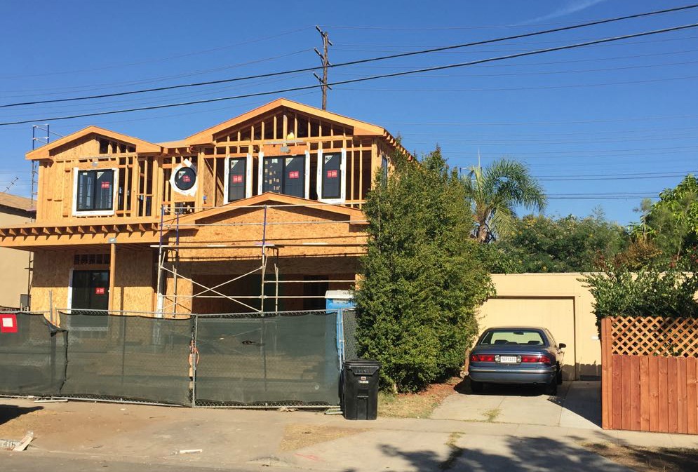 Building new large homes next to small existing homes.